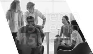 A group of people sitting around a table. Description generated by AI