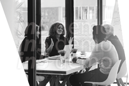 A group of people sitting around a table. Description generated by AI